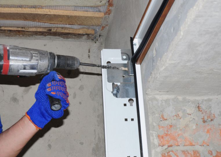 New garage door track being installed on a Brownsville home